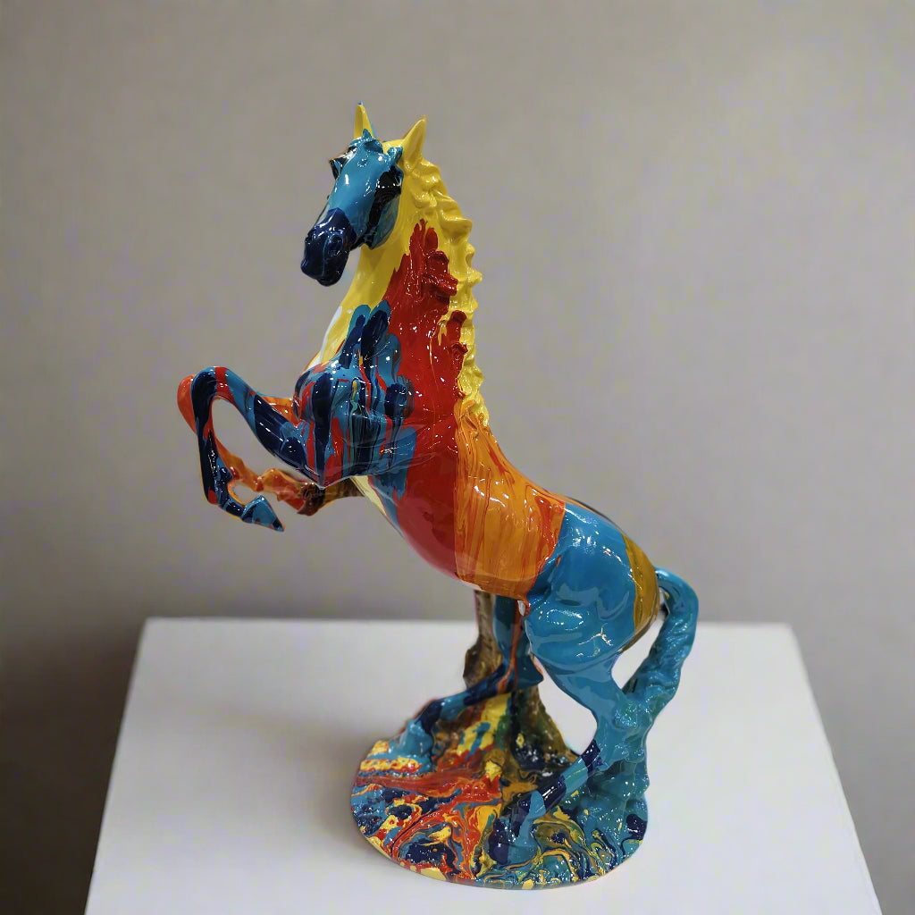 Colorful horse sculpture on a white pedestal against a plain background