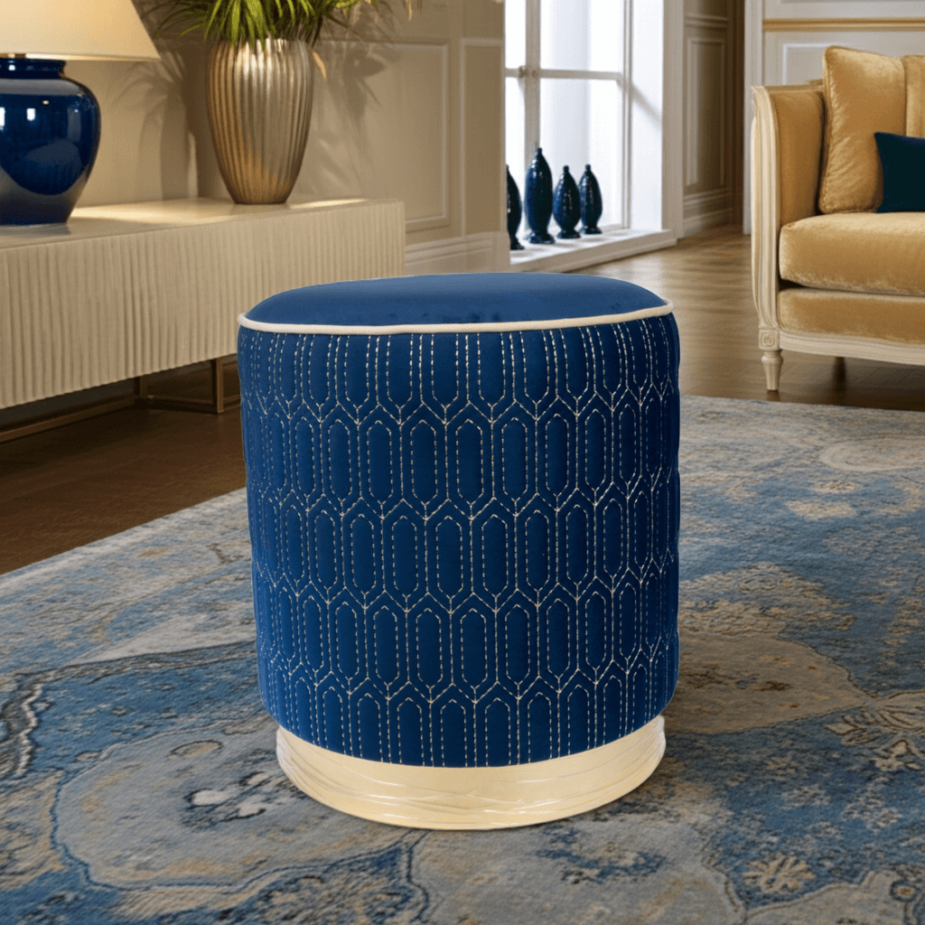 Geometric Stitched Velvet Ottoman in Navy with cream stitching in a modern living room.