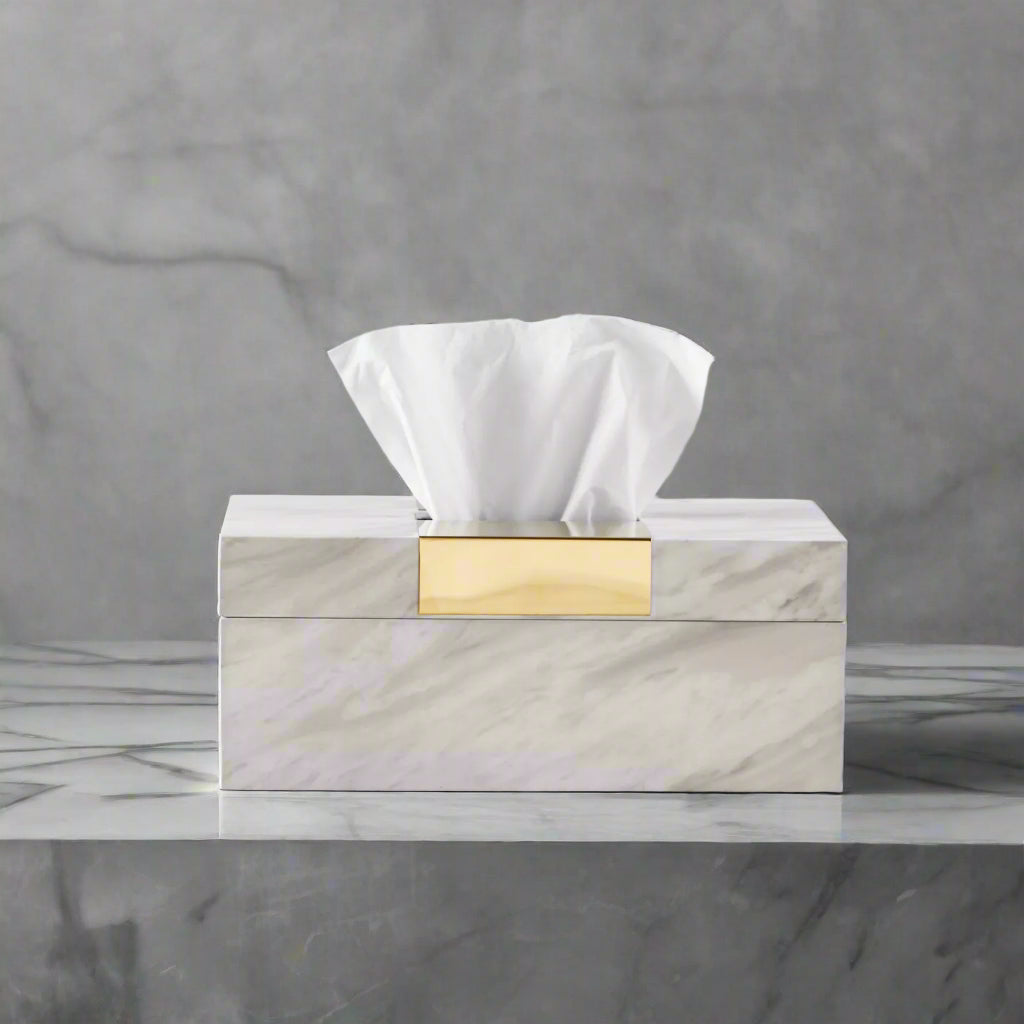 Marble-patterned tissue box with gold accent on a light gray background