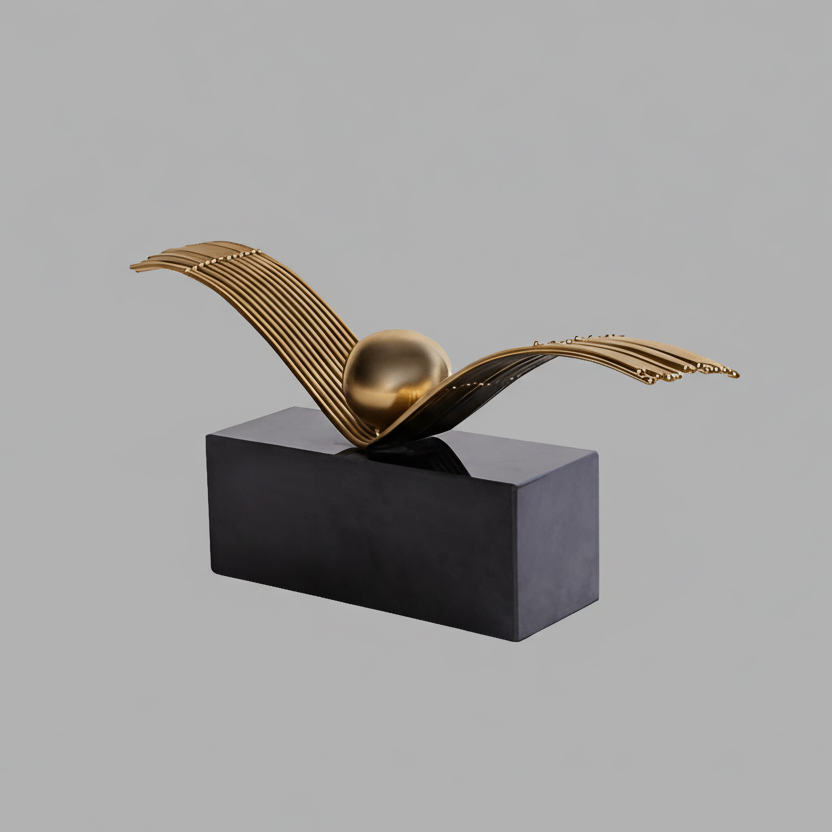Decorative sculpture with gold wing-like structure on a black rectangular base against a gray background