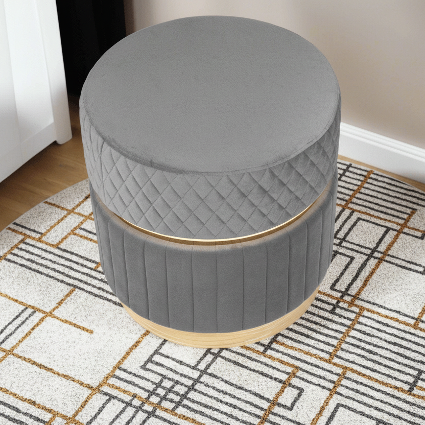 Gray round ottoman with quilted design on a patterned rug