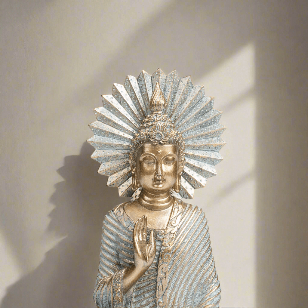 Decorative statue of a seated figure with intricate detailing on a plain background