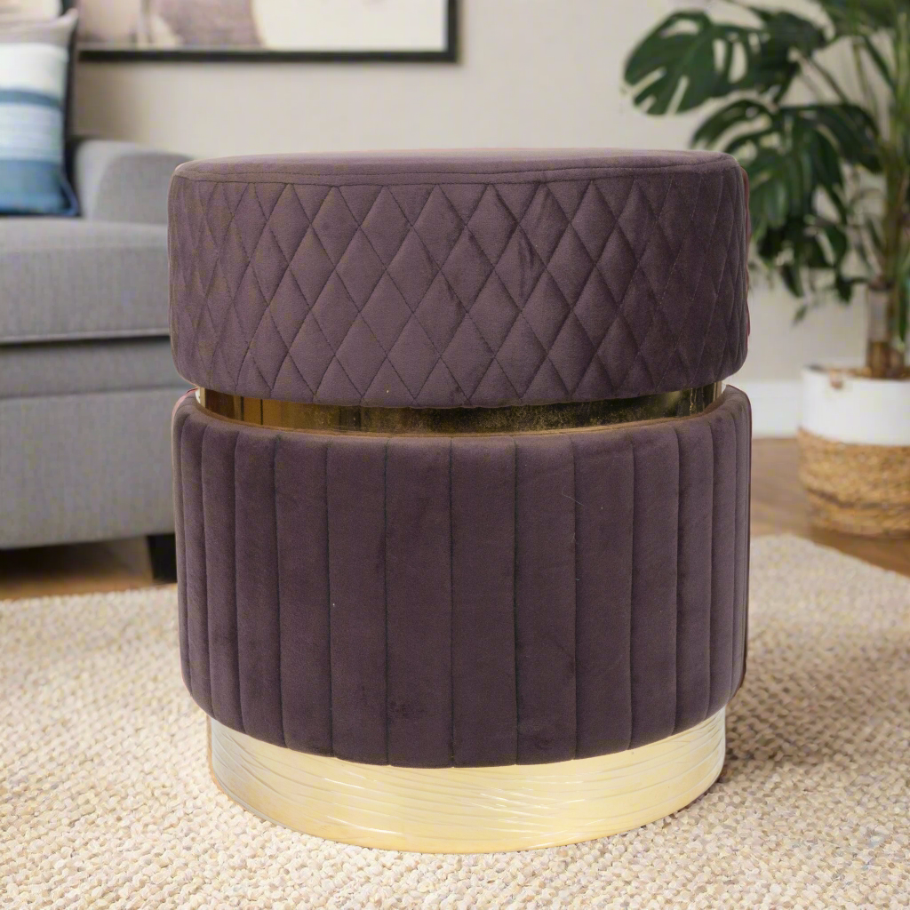 Purple ottoman with gold accents in a living room setting