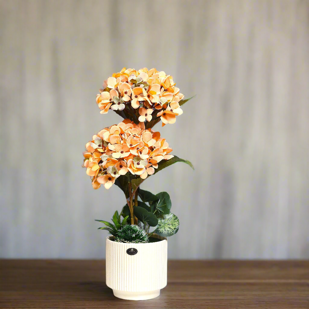 Tiered Bloom: Artificial Peach Hydrangea Arrangement in Ceramic Ribbed Cream Pot