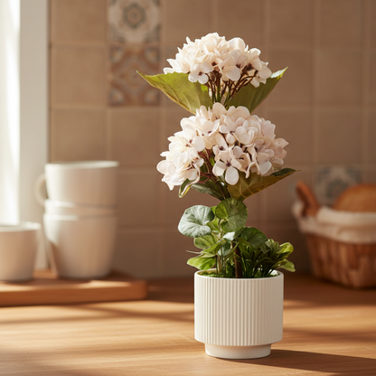Artificial flower arrangement in a pot on a gray background