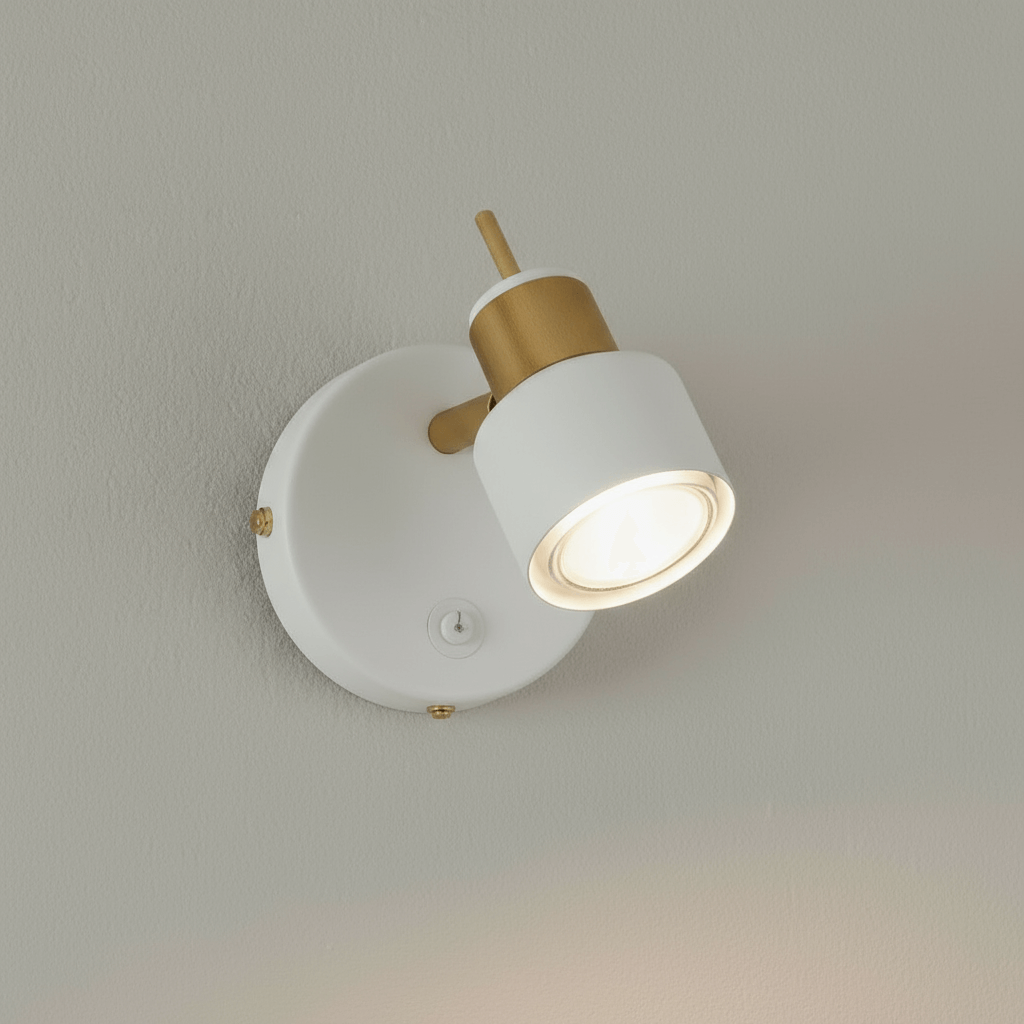 Wall-mounted light fixture with white shade and gold accents on a neutral wall.