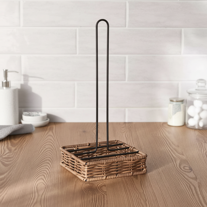 Wicker dish drying rack with black metal stand on a wooden surface.