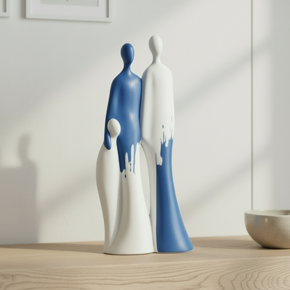 Two ceramic figures, one blue and one white, standing together on a reflective surface with a neutral background.