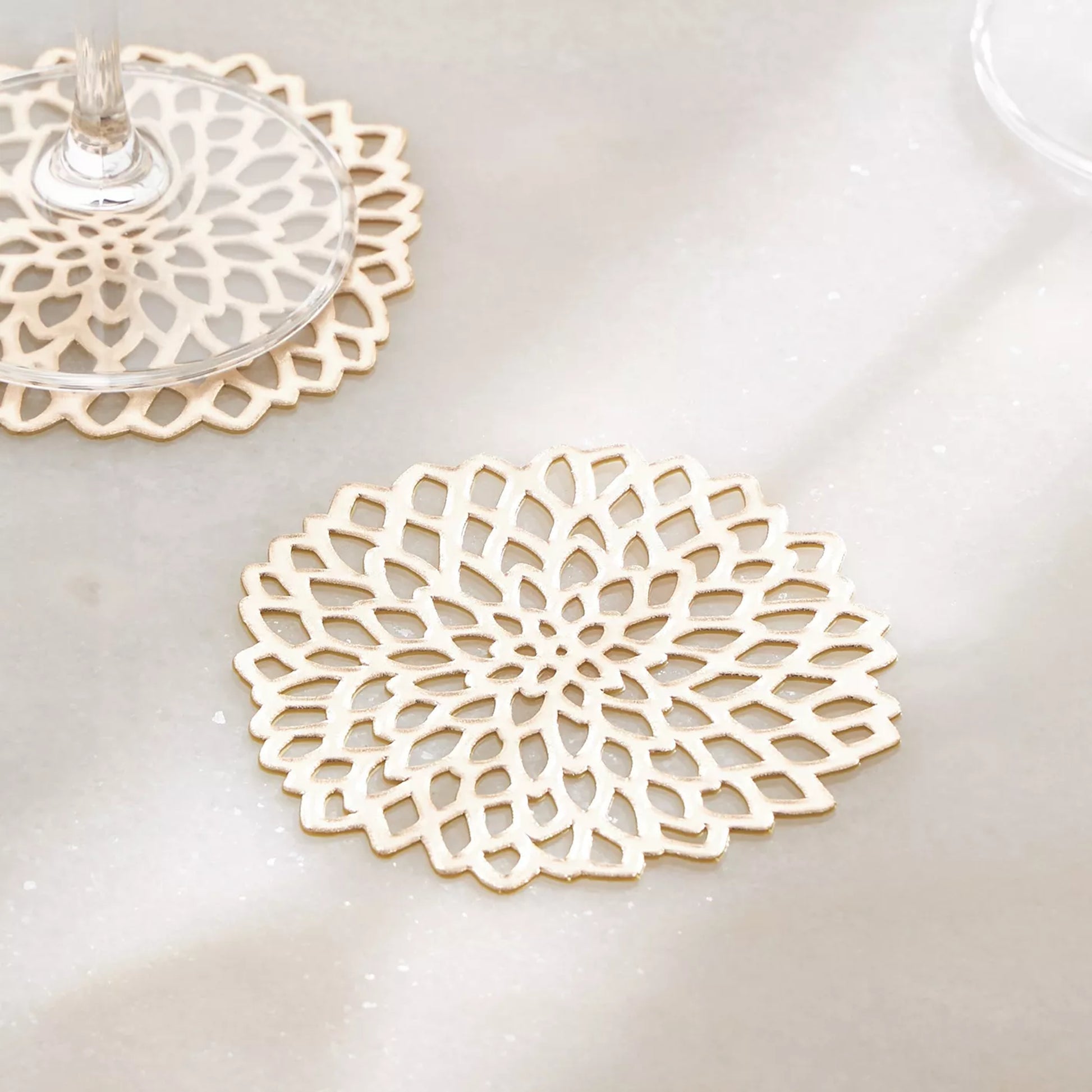 Decorative white lace coasters on a light surface