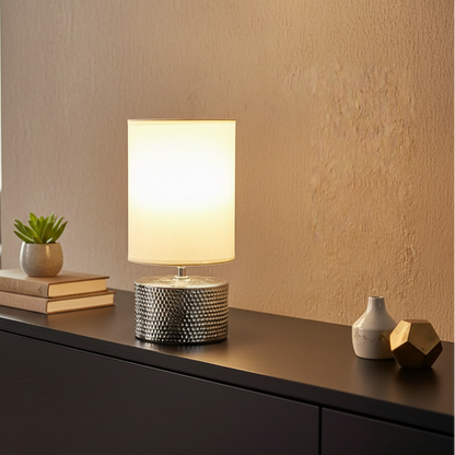 Table lamp with textured base on a wooden surface