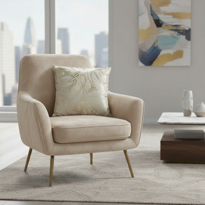 Beige armchair with a decorative pillow in a modern living room setting.