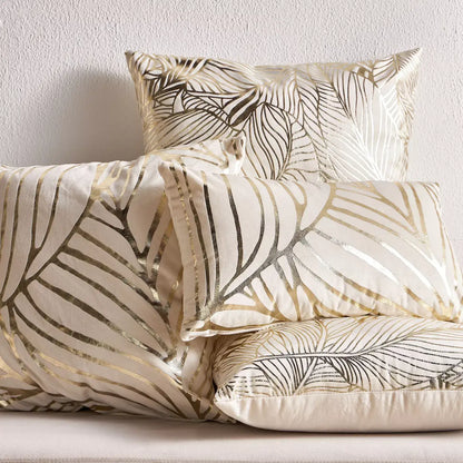 Decorative pillows with leaf pattern on a plain background
