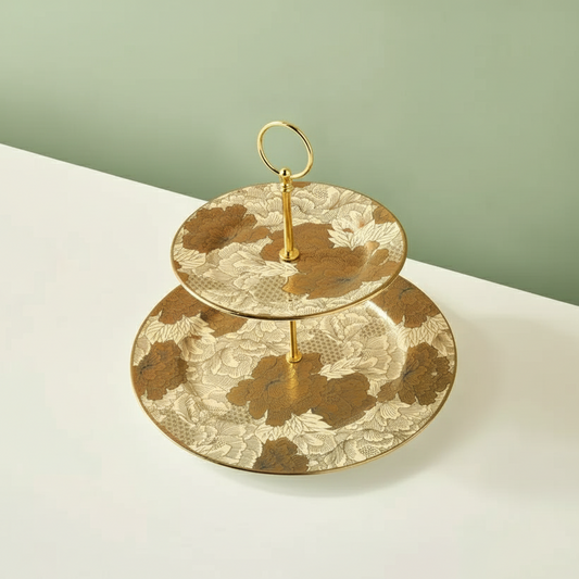 Two-tiered decorative stand with floral patterns on a light surface and green background