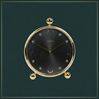 Decorative clock with gold rim and base on a white background