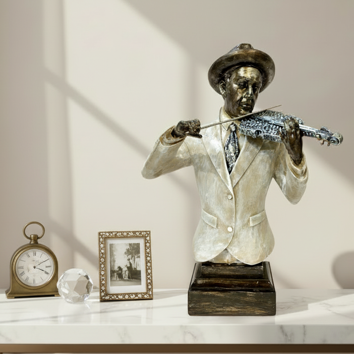 Statue of a man playing a violin on a marble surface with decor items.