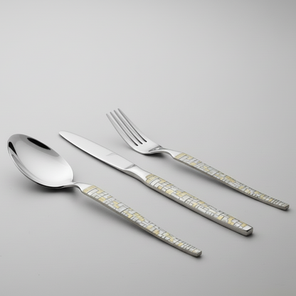 Set of silver cutlery with decorative handles on a gray background