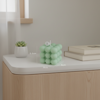 Cube-shaped soy wax candle with green bubbles