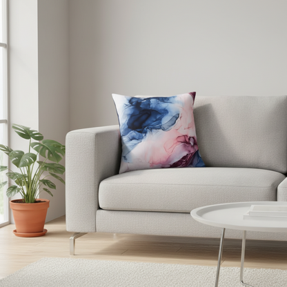 Decorative pillow with abstract design on a gray sofa in a living room setting.