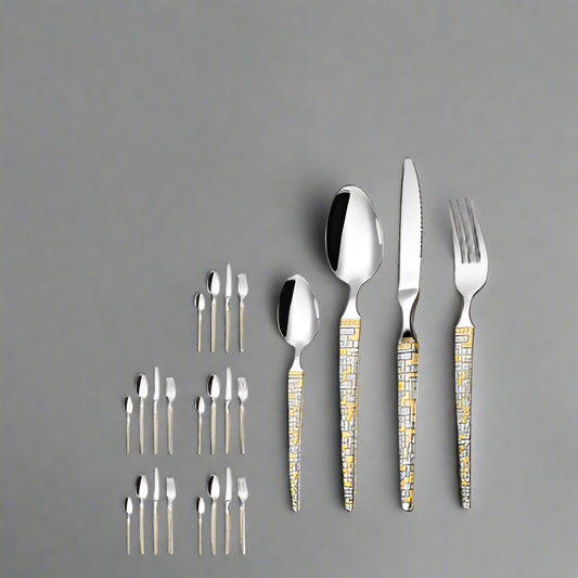 Silver cutlery set with gold accents on a white background