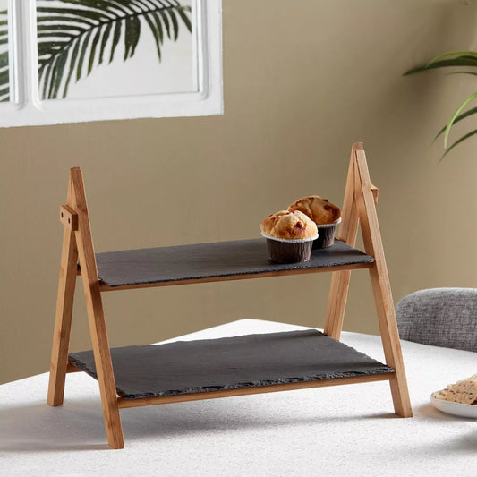 Wooden pet ramp with two bowls of food on a white surface against a beige wall.