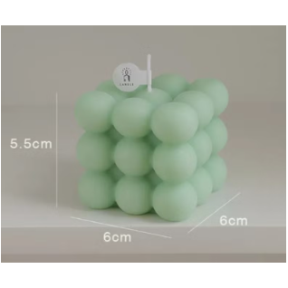 Cube-shaped soy wax candle with green bubbles