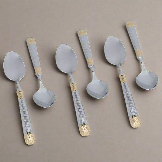 Set of six spoons with decorative handles on a white background