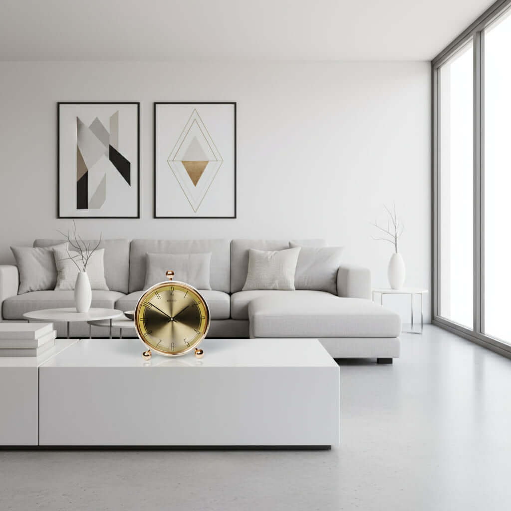 Gold clock with 'Aristo' branding on a white background