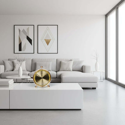 Gold clock with 'Aristo' branding on a white background