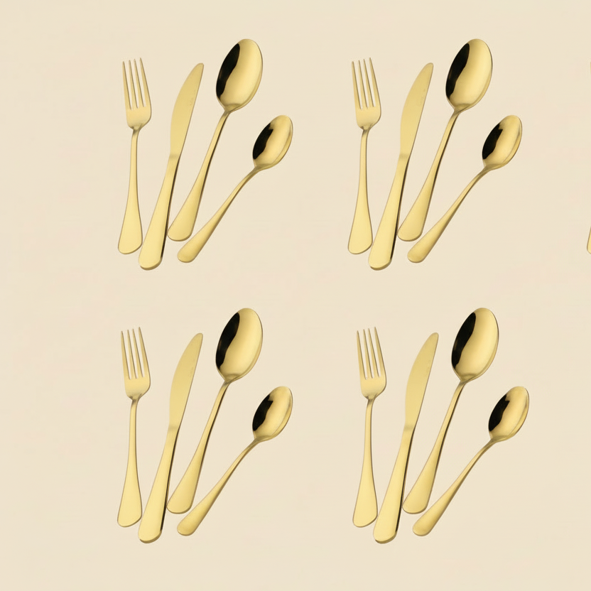 Set of gold cutlery including forks and knives on a beige background