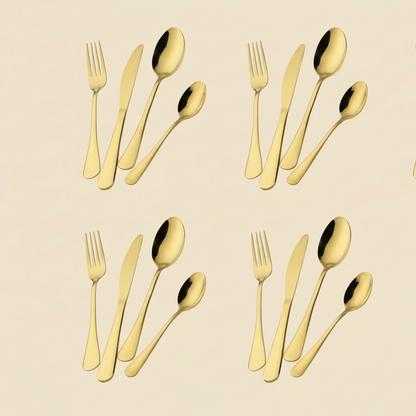 Set of gold cutlery including forks and knives on a beige background