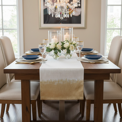 Dining room table set for a meal with candles, flowers, and place settings.