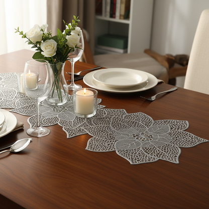 Dining table set with lace table runner, candles, and flowers in a home setting.