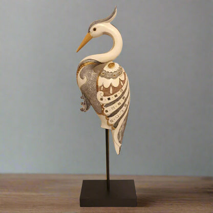 Decorative heron sculpture on a stand with intricate patterns