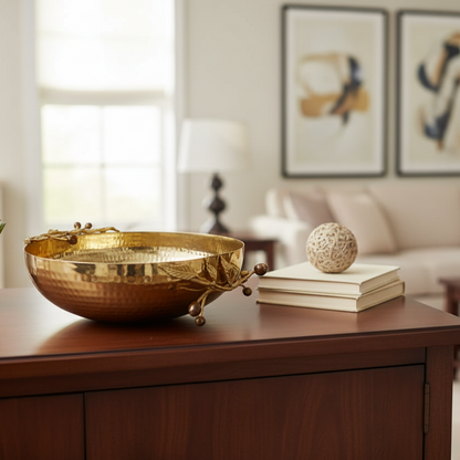 Gold decorative bowl on a wooden surface with a blurred living room background
