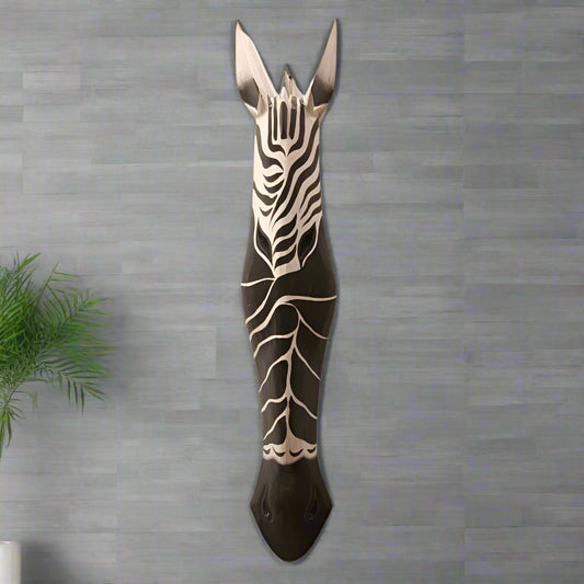 Decorative zebra head wall art on a textured gray wall.