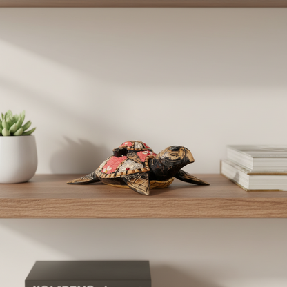 Decorative turtle sculpture on a wooden surface