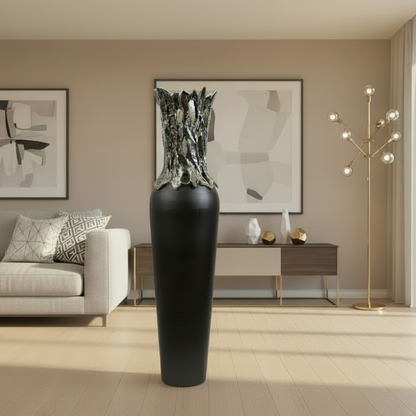 Modern living room with a large black vase, gray sofa, and abstract art on the wall.
