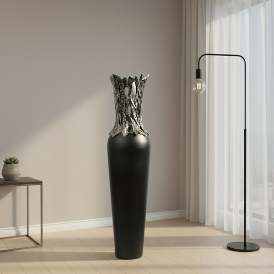 Modern interior with a tall black vase, small table, and floor lamp.