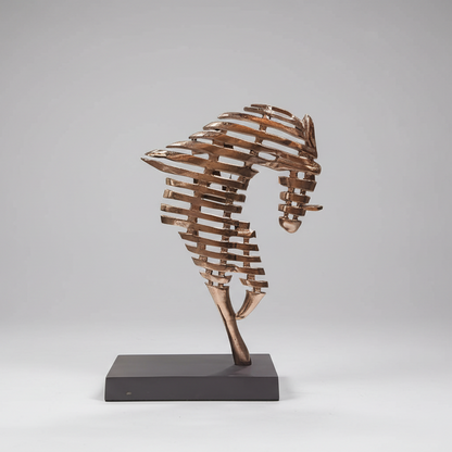 Bronze seahorse sculpture on a gray background
