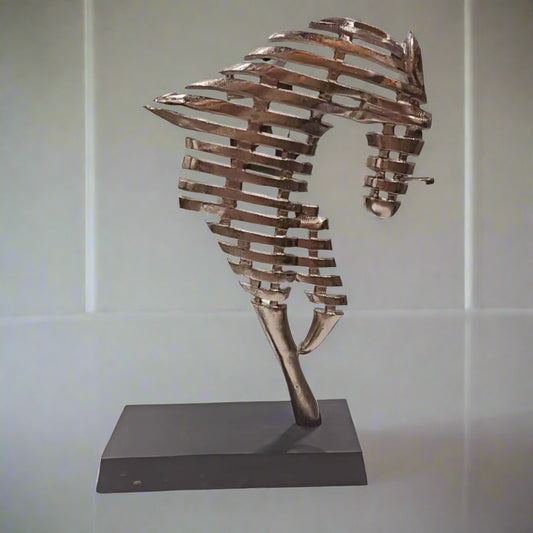 Bronze sculpture on a stand against a light background