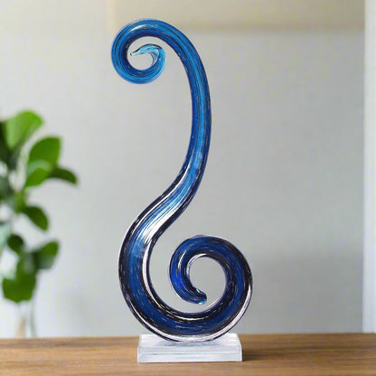 Blue glass sculpture on a white background