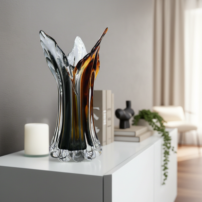 Decorative glass vase on a white surface with a blurred background