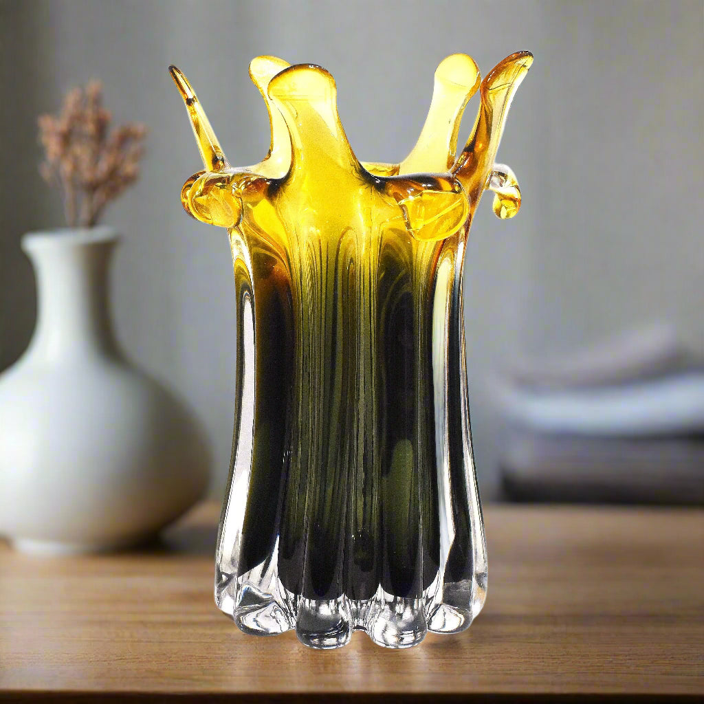 Glass vase with yellow and black gradient on a white background