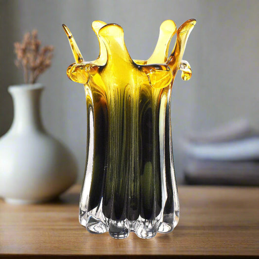 Glass vase with yellow and black gradient on a white background