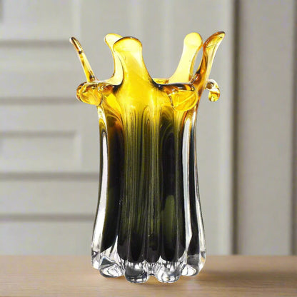 Glass vase with yellow and black gradient on a white background