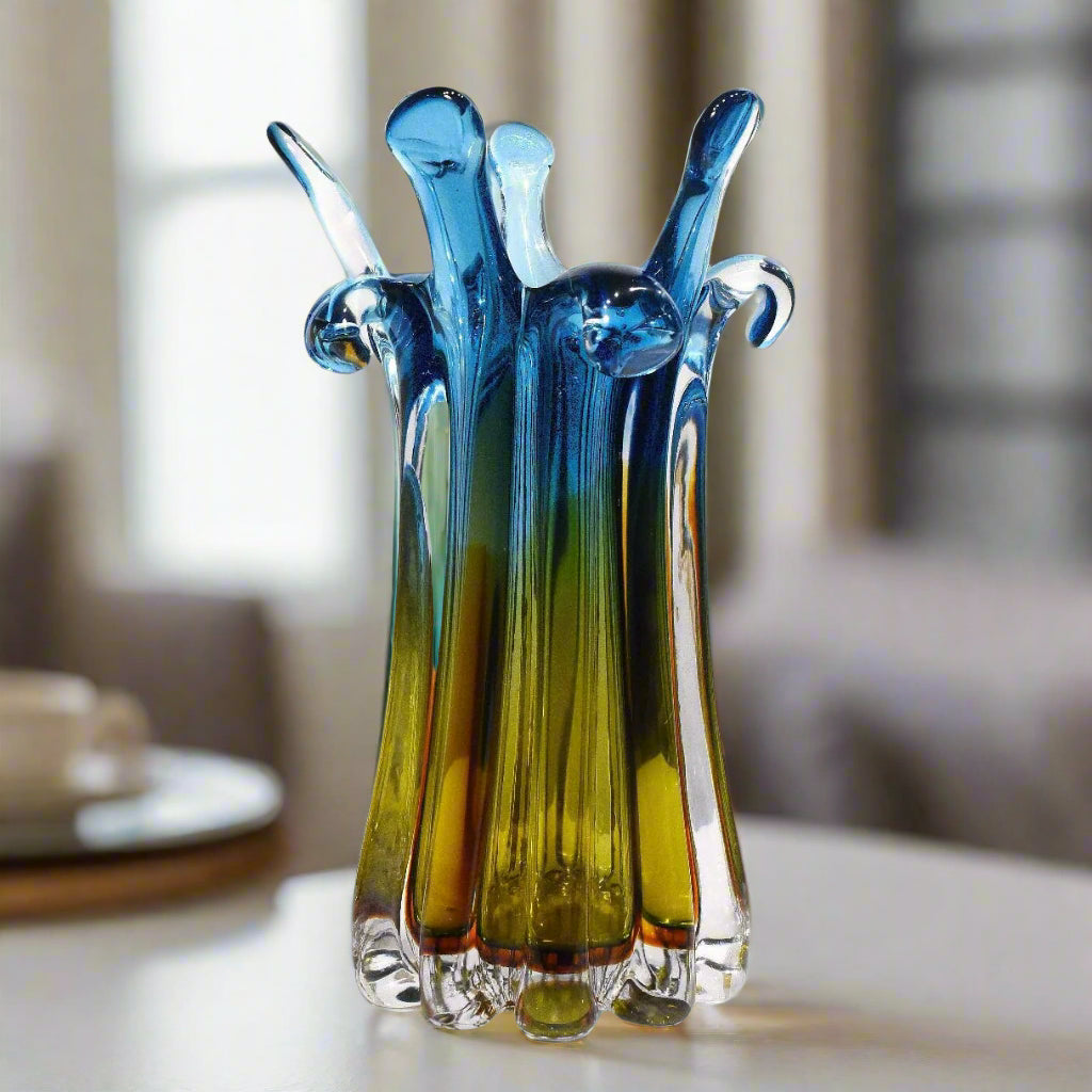 Colorful glass vase with a gradient from blue to green on a white background