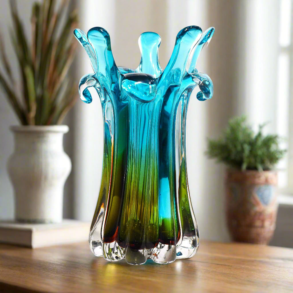Turquoise and green glass vase on a white background