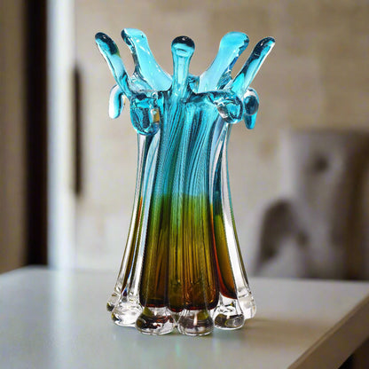 Glass sculpture resembling a hand with blue and green gradient