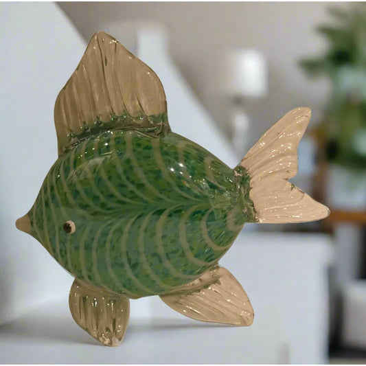 Decorative fish-shaped object with green and beige colors on a light gray background