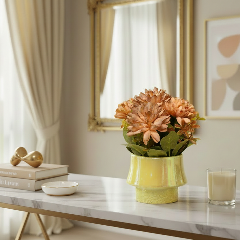 Decorative setup on a marble table with a vase of flowers, books, and a glass.